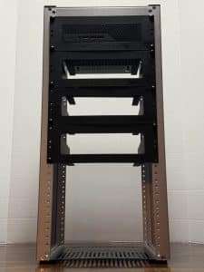 Four custom 3D printed 10 inch rack mounts installed in a DeskPi RackMate T2, with a Minisforum MS-01 in the top slot and open mounts below for three Minisforum MS-A2 units — a MYOG homelab project designed in OpenSCAD.