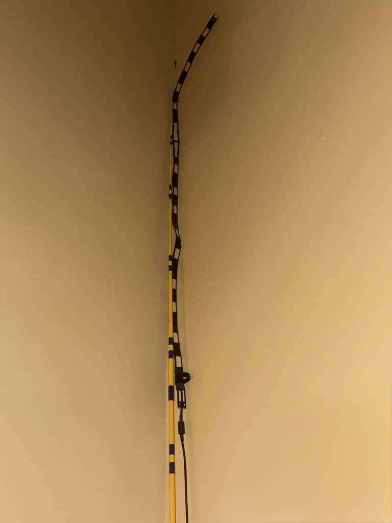 A J-Pole antenna in the corner held up by a fishing pole. Useful for connecting to ham radio nets.